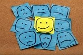 8096109-positive-attitude-or-optimism-concept--happy-smiley-face-on-yellow-sticky-note-surrounded-by-sad-unh